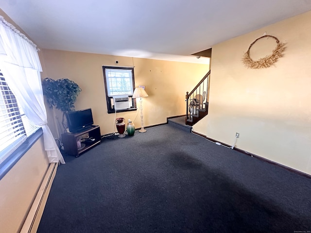 interior space with carpet, cooling unit, and a baseboard heating unit