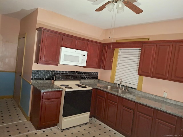 kitchen featuring ceiling fan, sink, white appliances, tasteful backsplash, and dark stone counters