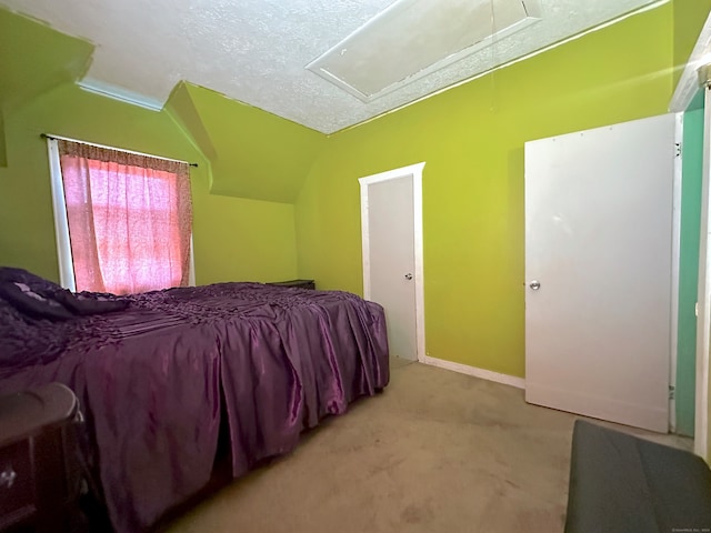 bedroom featuring a textured ceiling, lofted ceiling, and light colored carpet