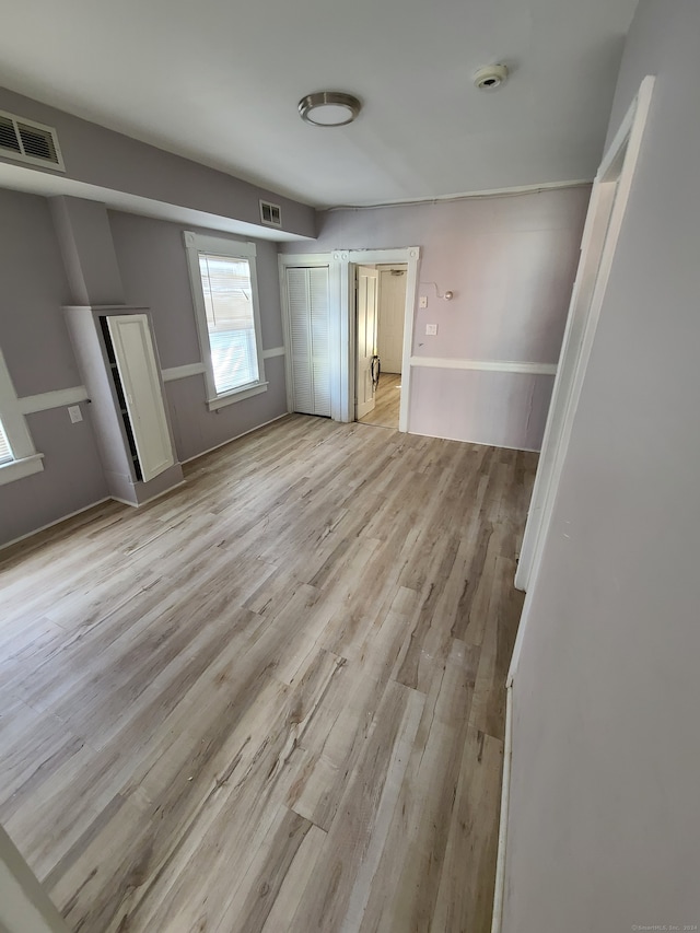 unfurnished bedroom with light wood-type flooring