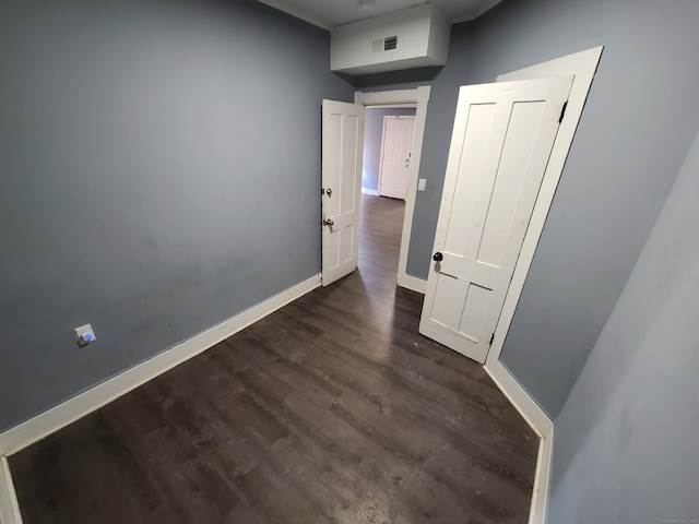 corridor featuring dark hardwood / wood-style flooring