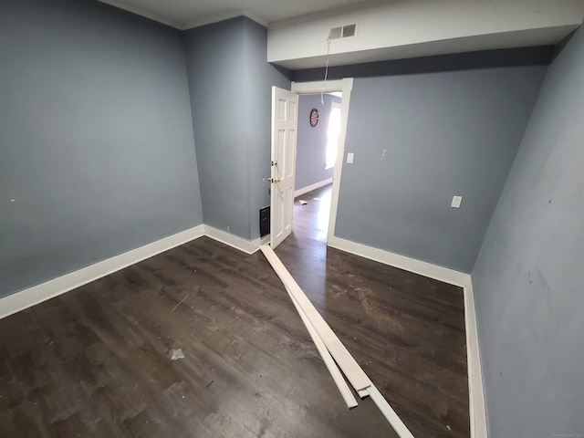 spare room featuring dark wood-type flooring