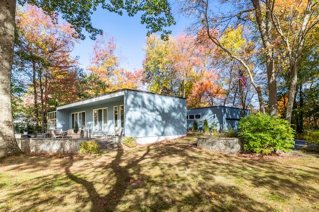 back of house with a yard and covered porch