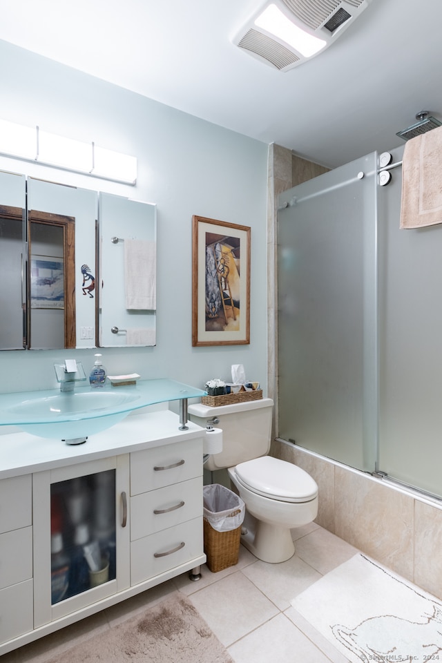 full bathroom with tile patterned flooring, vanity, toilet, and combined bath / shower with glass door