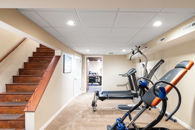 workout area with carpet and a paneled ceiling