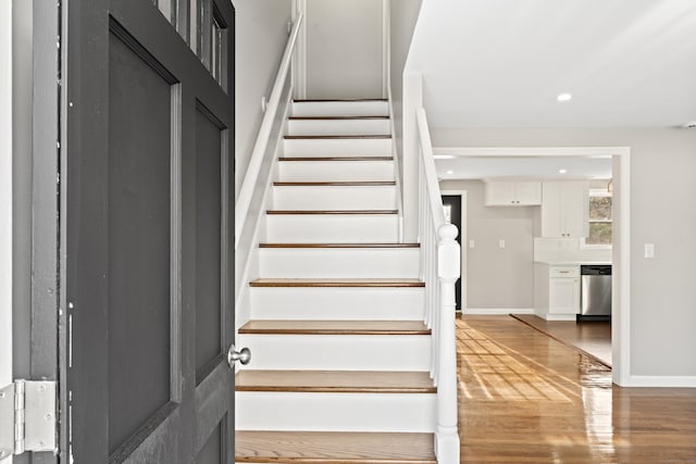 stairs with hardwood / wood-style flooring