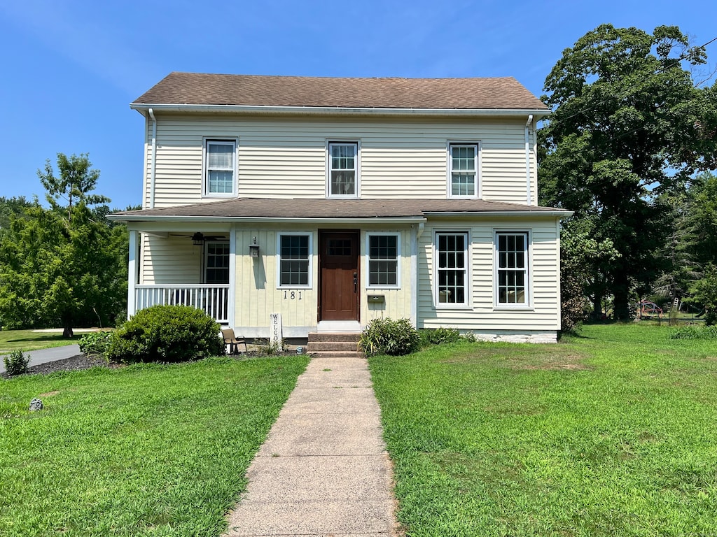 view of front of property with a front yard and covered porch