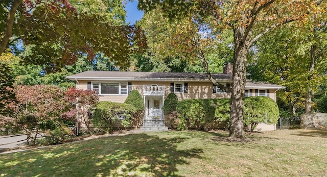 raised ranch featuring a front lawn