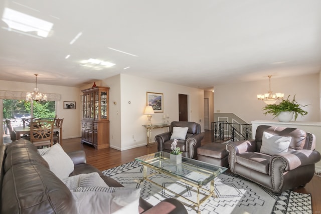 living room featuring a notable chandelier and dark hardwood / wood-style flooring