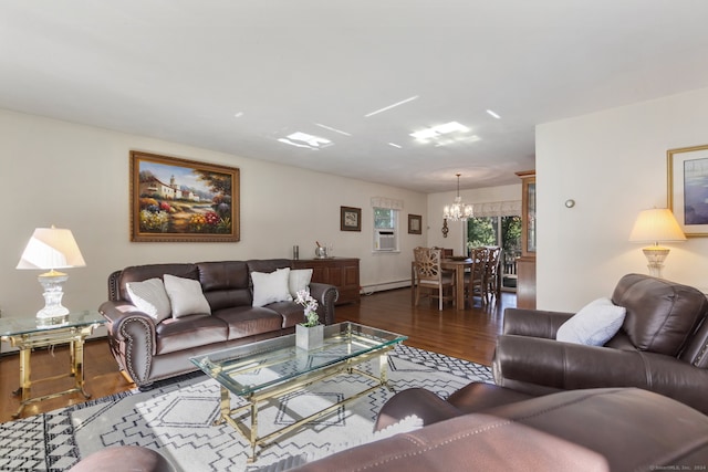 living room featuring hardwood / wood-style flooring, a notable chandelier, and baseboard heating