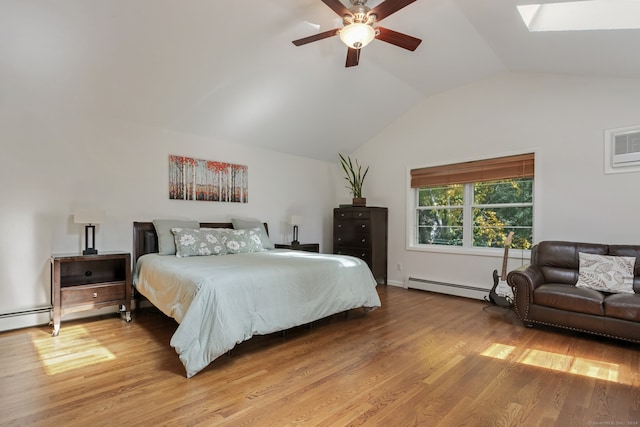 bedroom with a wall unit AC, ceiling fan, light hardwood / wood-style floors, lofted ceiling with skylight, and a baseboard radiator