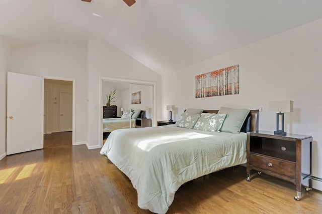 bedroom with vaulted ceiling, ceiling fan, and hardwood / wood-style floors