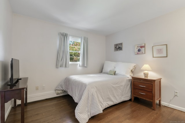 bedroom with dark hardwood / wood-style flooring