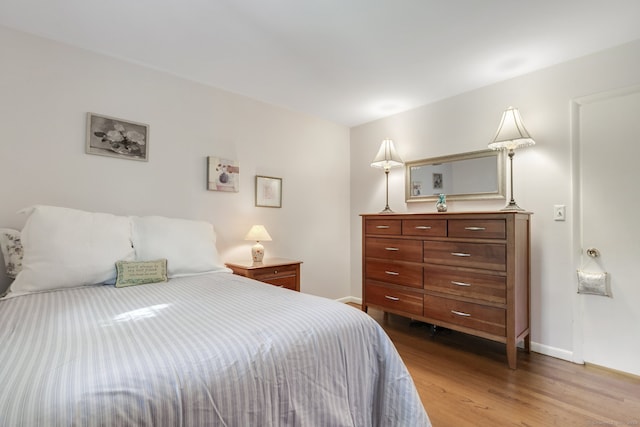 bedroom with hardwood / wood-style flooring