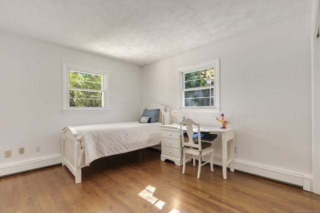 bedroom with hardwood / wood-style flooring and multiple windows