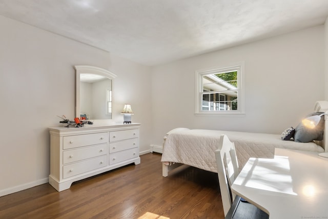 bedroom with a baseboard radiator and dark wood-type flooring