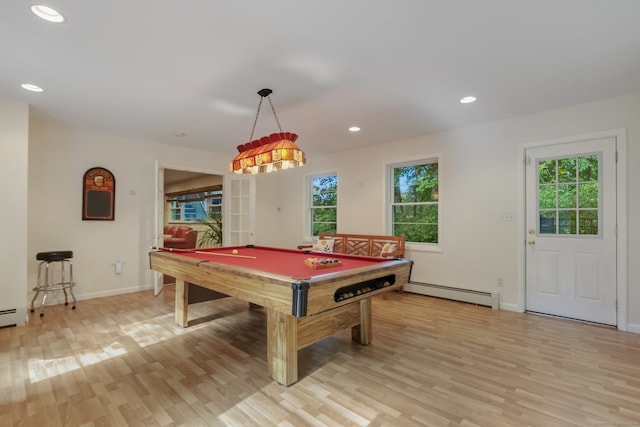 recreation room with billiards, a baseboard radiator, light wood-type flooring, and a wealth of natural light