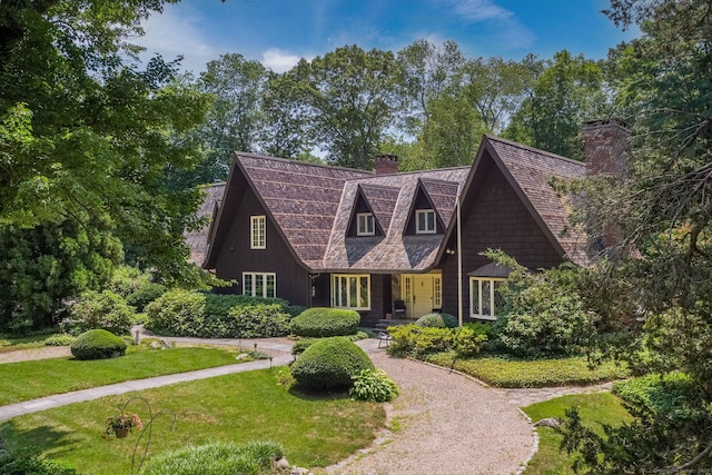 6 Tantummaheag Rd, Old Lyme, CT 06371 - view of front facade with a chimney and a front lawn