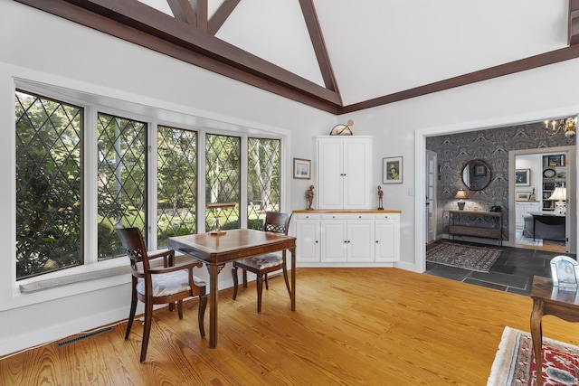 6 Tantummaheag Rd, Old Lyme, CT 06371 - dining room featuring high vaulted ceiling, beam ceiling, a chandelier, and light wood-type flooring