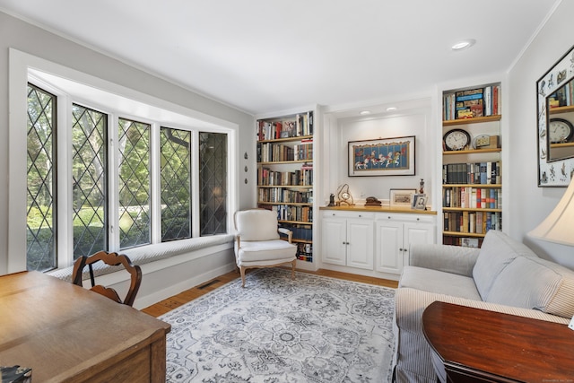 6 Tantummaheag Rd, Old Lyme, CT 06371 - sitting room featuring light wood-style floors, built in features, and crown molding