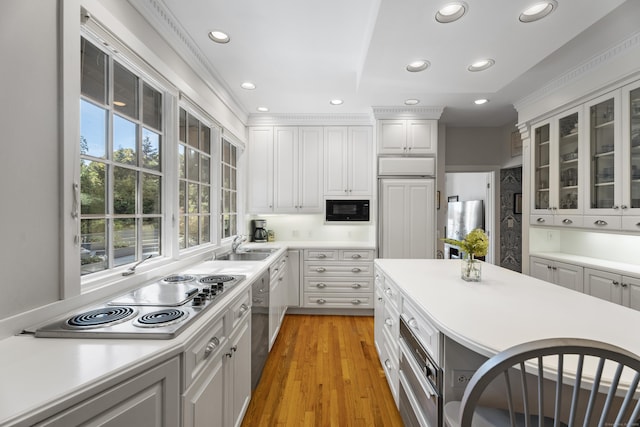 6 Tantummaheag Rd, Old Lyme, CT 06371 - kitchen with stainless steel appliances, recessed lighting, glass insert cabinets, light countertops, and light wood finished floors