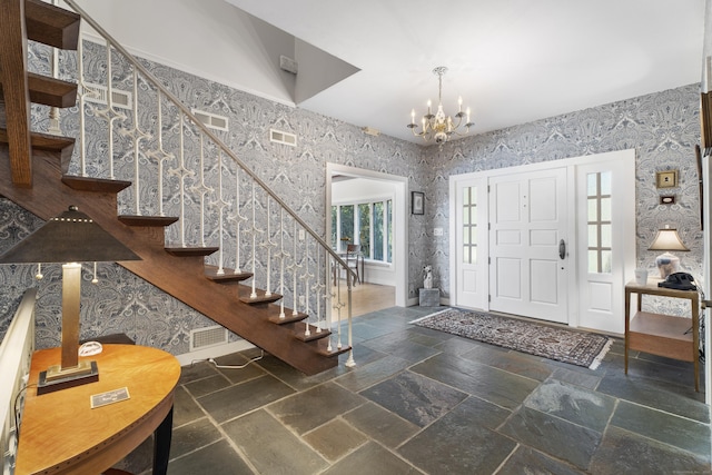 6 Tantummaheag Rd, Old Lyme, CT 06371 - entrance foyer with wallpapered walls, a chandelier, stairs, and stone tile floors