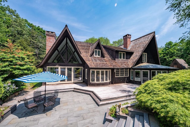 6 Tantummaheag Rd, Old Lyme, CT 06371 - back of property with a chimney, a deck, a patio, and french doors