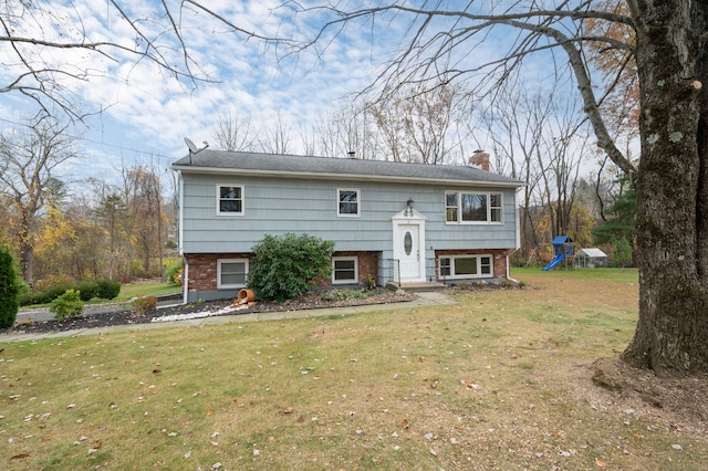 view of front of house with a front lawn and a playground