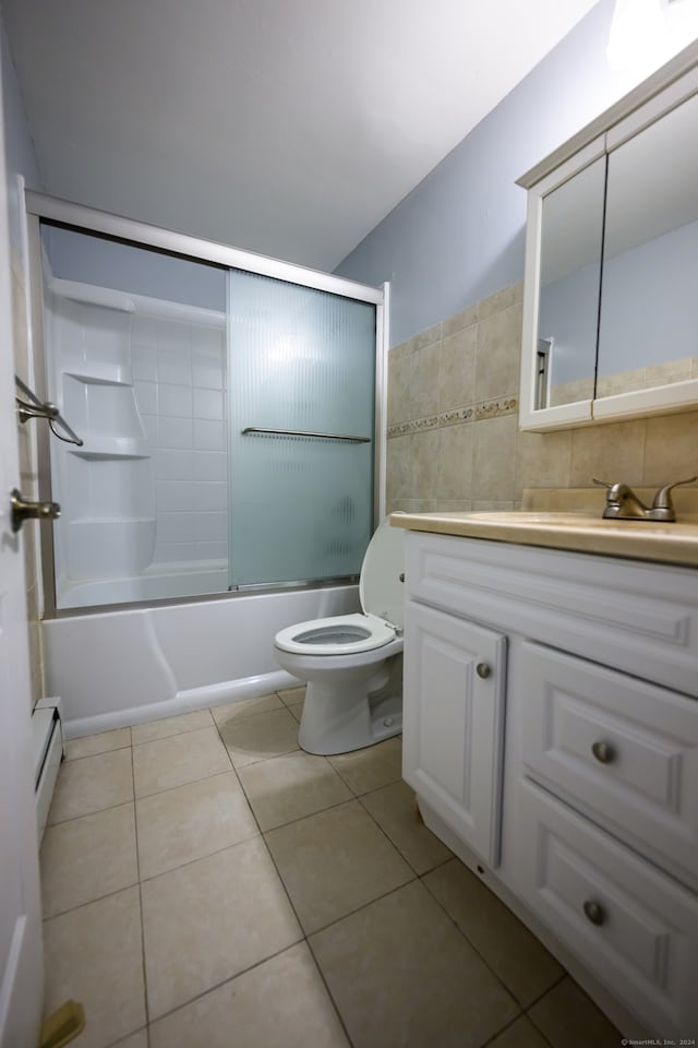 full bathroom featuring a baseboard radiator, bath / shower combo with glass door, toilet, vanity, and tile patterned floors