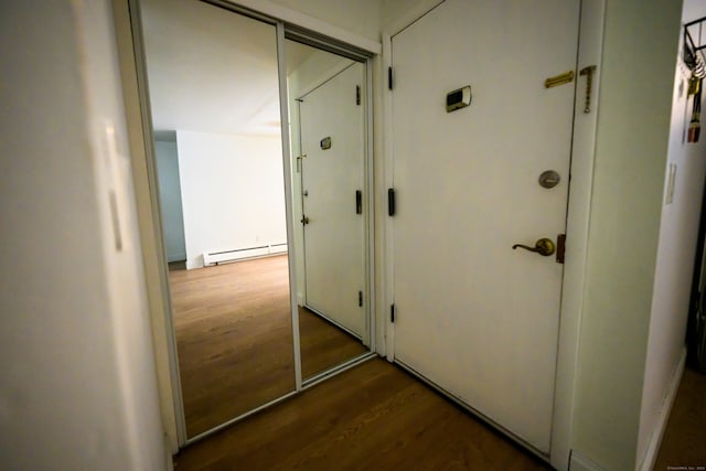 hallway with hardwood / wood-style floors and baseboard heating