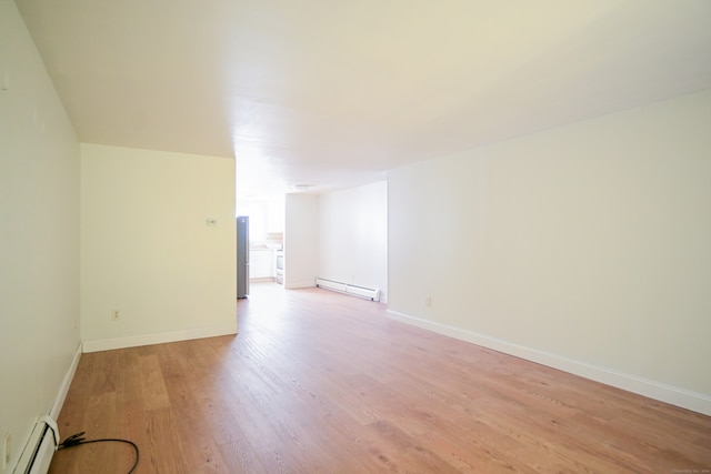 spare room featuring light hardwood / wood-style flooring and a baseboard heating unit