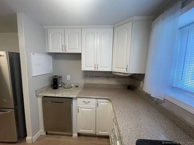 kitchen featuring appliances with stainless steel finishes and white cabinetry