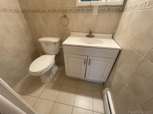 bathroom featuring vanity, a baseboard heating unit, toilet, and tile walls