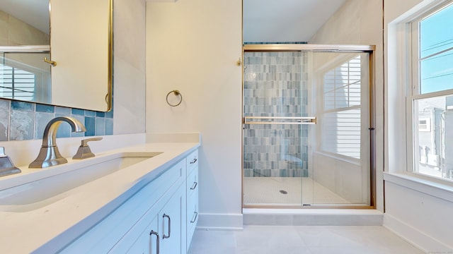 bathroom featuring backsplash, tile patterned floors, a shower with shower door, and vanity