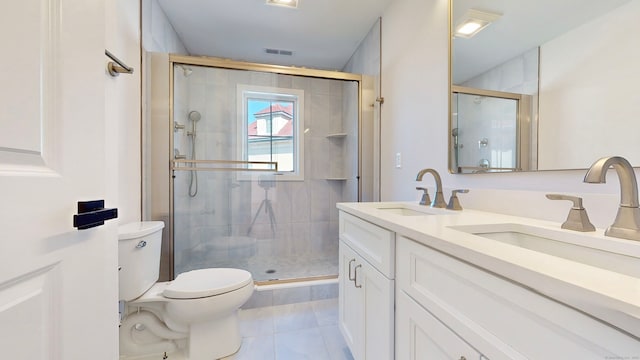 bathroom with tile patterned floors, vanity, walk in shower, and toilet