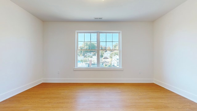 spare room featuring light hardwood / wood-style flooring