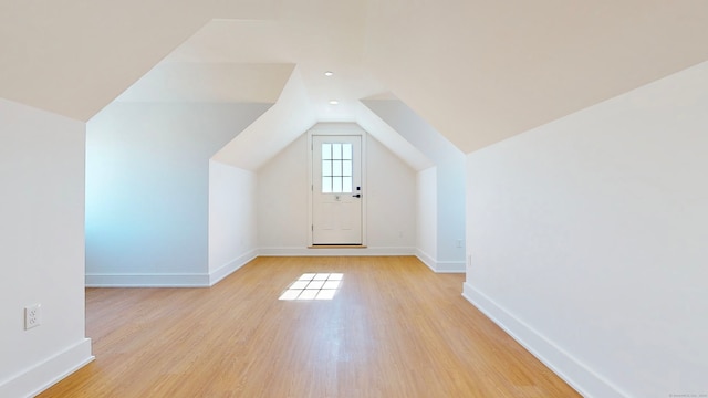 bonus room featuring light wood-type flooring and lofted ceiling