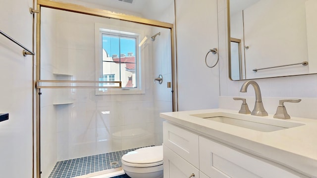 bathroom featuring walk in shower, vanity, and toilet