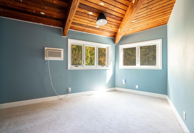 carpeted empty room with an AC wall unit, vaulted ceiling with beams, and wooden ceiling