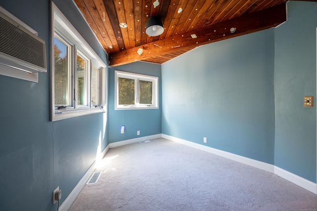 carpeted spare room with beamed ceiling, a wall mounted air conditioner, and wood ceiling