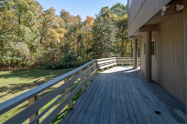 wooden deck featuring a yard