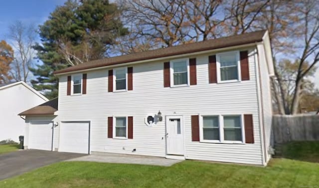 view of front facade featuring a garage and a front lawn