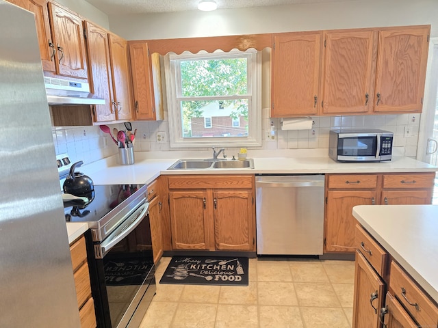 kitchen with stainless steel appliances, backsplash, sink, ventilation hood, and light tile patterned floors