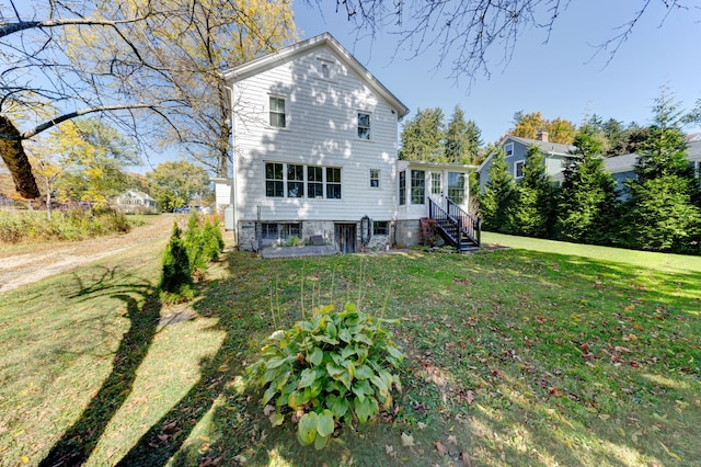 rear view of house with a lawn