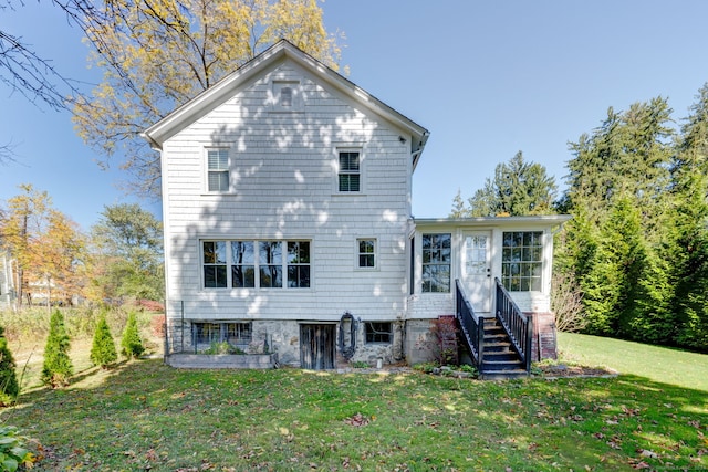 rear view of house featuring a yard