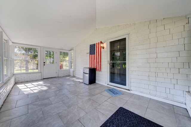 unfurnished sunroom with vaulted ceiling