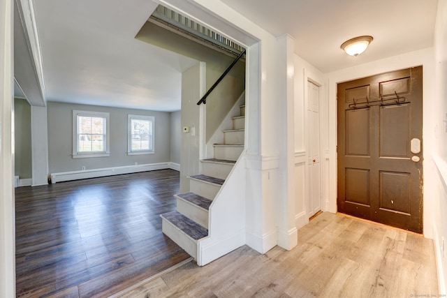 entryway featuring a baseboard heating unit and light hardwood / wood-style floors