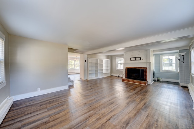 unfurnished living room with hardwood / wood-style flooring, a fireplace, and a baseboard radiator