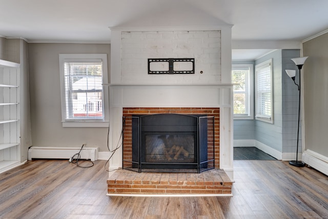 details featuring a fireplace, ornamental molding, hardwood / wood-style floors, and baseboard heating