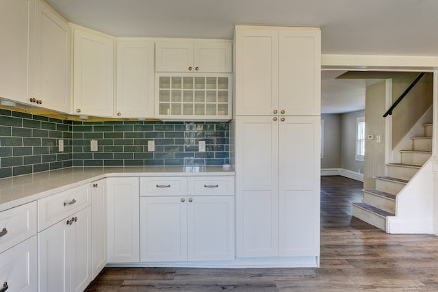 kitchen featuring white cabinets, hardwood / wood-style floors, and decorative backsplash